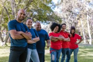 Services Diverse group of adults bonding and enjoying team activity in a park.